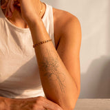 Tatouage géométrique marguerite et fleur de cerisier